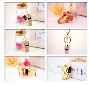 Macro view of crystal-encrusted whistle keychains in multiple vibrant color options