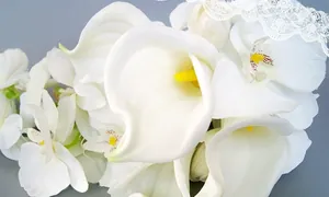 Macro detail of artificial white calla lily and orchid bridal bouquet for wedding
