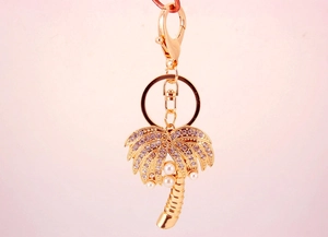 Golden palm tree keychain with sparkling rhinestones and delicate pearls detail