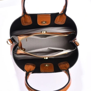 Top view of tote bag interior showing multi-layer compartments and golden hardware details