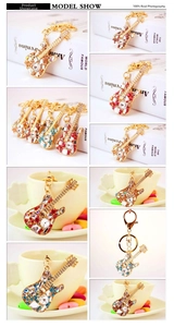 Detailed close-up of guitar shaped keychains featuring colorful crystal rhinestones