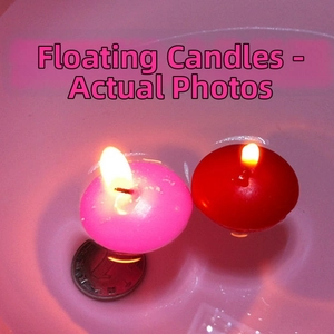 Close-up of pink and red floating candles burning in water for wedding decor
