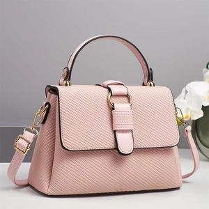 Elegant pink woven leather handbag with gold metal hardware and adjustable shoulder strap