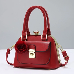 Chic red contrast top-handle pillow bag with gold hardware and elegant crystal accent