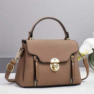 Brown woven texture handbag with gold circular lock and adjustable shoulder strap for women