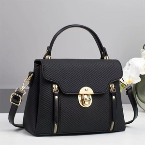 Elegant black textured canvas handbag with gold hardware and removable shoulder strap