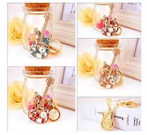 Close-up of guitar keychain with multi-color rhinestones and polished metal finish