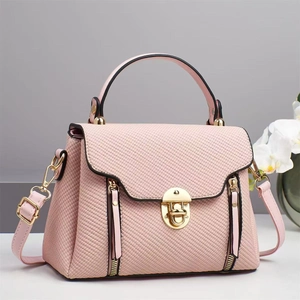 Elegant pink canvas textured crossbody handbag with gold hardware and stylish flap design
