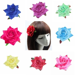 Detail showing artificial rose hair clips in multiple colors with leaf accents