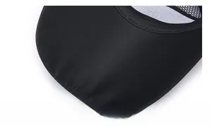 Detail of curved brim on black breathable mesh cap with moisture-wicking fabric