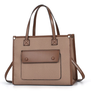 Classic canvas tote bag with brown leather trim and dual handles for summer fashion