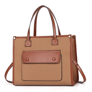 Detail showing high-quality canvas and leather stitching with front magnetic pocket