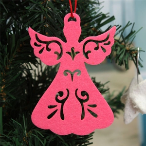 Close-up of pink felt angel ornament with laser-cut details on green Christmas tree