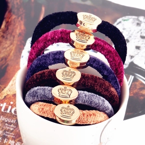 Detail of velvet hair scrunchies with gold crown buckles in 6 assorted colors
