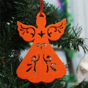 Close-up of orange felt angel ornament with cutout details hanging on a Christmas tree