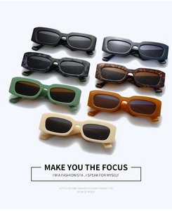 Flat lay of seven colorful rectangle sunglasses in various fashion-forward frame colors