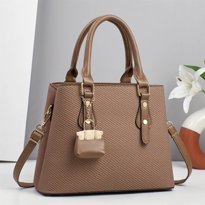 Vintage woven shoulder bag in dark khaki with top handle and matching mini charm