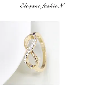 Detail of elegant gold infinity ring featuring sparkling pavé set rhinestones