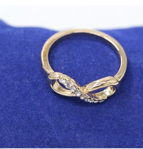 Close-up of a gold-plated infinity ring featuring micro-pave sparkling crystals