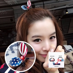 Detail of American flag pattern bunny ear and bow hair ties with star and stripe designs