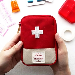 Portable red canvas first-aid pouch with white cross embroidery for outdoor travel