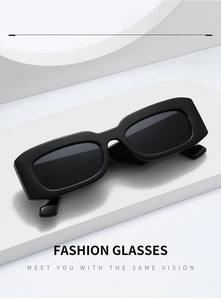 Close-up of black rectangular sunglasses on a white minimalist geometric platform