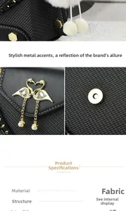Detail of black fabric crossbody bag with swan diamond buckle and gold hardware