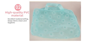 Close-up of waterproof PVC toiletry bag with white daisy print and mint green handles