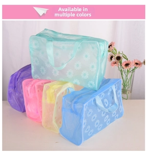 Close-up of five colorful waterproof PVC cosmetic bags with white daisy floral patterns