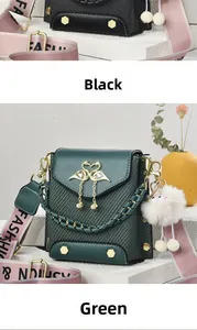 Detail of mini square bags with swan buckles and wide branded fabric shoulder straps
