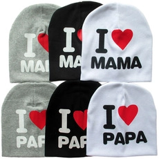 Close-up of knit baby hats in black, white and grey with I love Mama and Papa prints