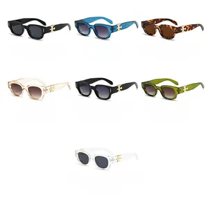 Detail of trendy oval sunglasses featuring metallic cross ornaments on the temples