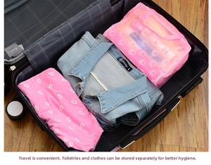 Pink floral mesh travel bag for toiletries shown packed inside a suitcase