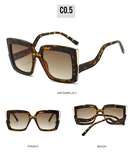 Detail view of leopard print square sunglasses with gold metal trim and gradient lenses