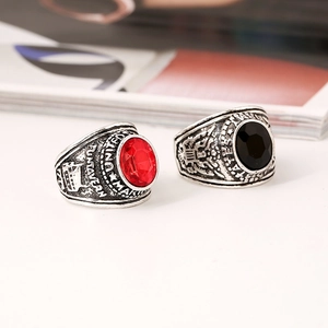 Vintage United States Marine Corps eagle rings featuring faceted red and black gemstones