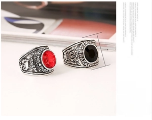 Macro view of vintage eagle signet rings featuring ruby and black stone with USMC engraving