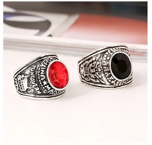 Detailed close-up of retro military rings featuring red and black inset gemstones