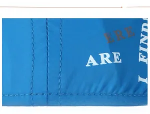 Detail of blue breathable fabric with white text print and sturdy double stitching