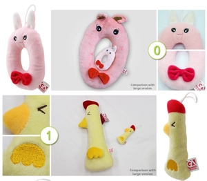 Detail showing plush rabbit and chick toy pendants with size comparison and embroidery