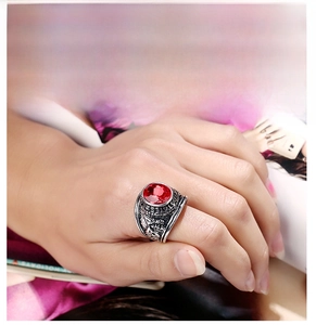 Macro shot of vintage silver ring featuring a large red gemstone and ornate carvings