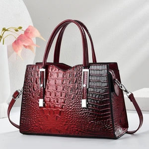 Elegant burgundy crocodile pattern leather handbag with silver accents and top handles