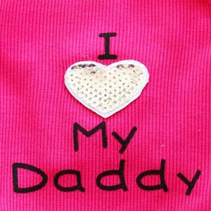 Detail of ribbed knit pet vest in rose red with silver heart sequin and embroidery