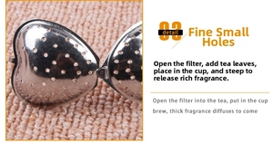 Close-up of heart-shaped stainless steel tea infuser with fine mesh holes for loose leaf