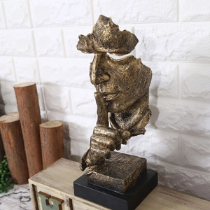 Vue détaillée de la sculpture Silence est d'Or en résine dorée avec texture vintage