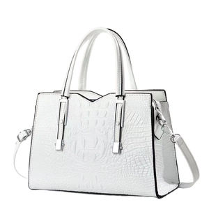White faux crocodile leather handbag with elegant silver hardware and detachable strap