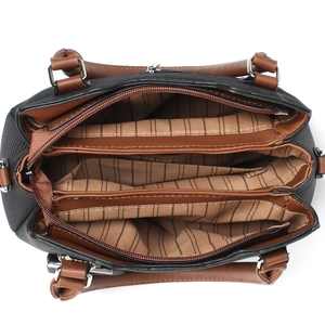 Top-down view of spacious bag interior featuring triple compartments and striped lining