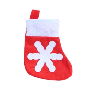 Detail of red felt Christmas stocking with white snowflake patterns and top hanging loop
