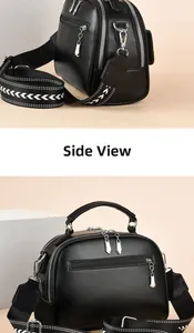 Dettaglio borsa a bauletto in pelle PU nera con scomparti a zip e tracolla geometrica