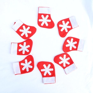 Eight red mini Christmas stockings with white snowflake patterns in a circle