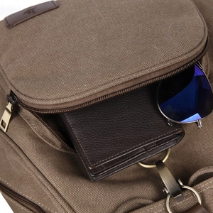 Vintage canvas backpack in dark brown with front pocket storage for wallet and sunglasses